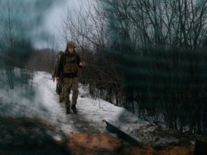 Service members of the Ukrainian armed forces walk at combat positions in Luhansk Region