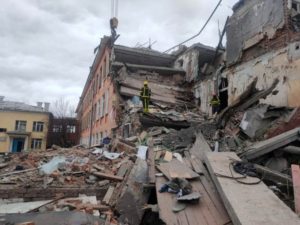 Rescuers remove debris from a school building damaged by shelling in Chernihiv