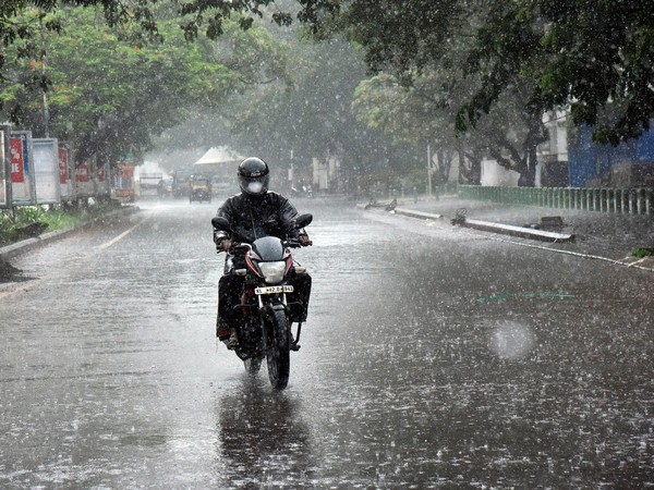 A biker rides during a rainy day after the southwest monsoon made landfall in Kerala