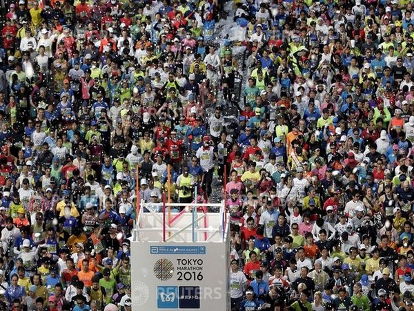 Runners fill the street in front of the Tokyo Metropolitan Government Building at the start of the Tokyo Marathon 2016 in Tokyo, Japan