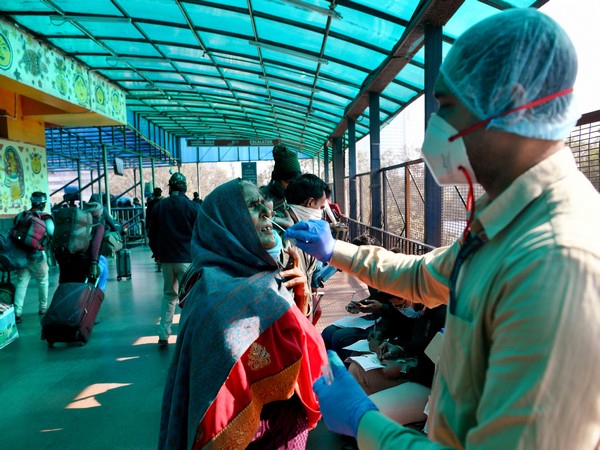 A healthcare worker takes a nasal swab sample for COVID-19 testing