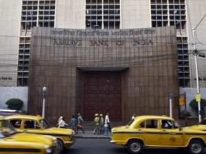 Commuters travel past Reserve Bank of India building in Kolkata