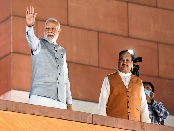 Prime Minister Narendra Modi waves to supporters at the BJP Headquarters following the party's win in Assembly elections