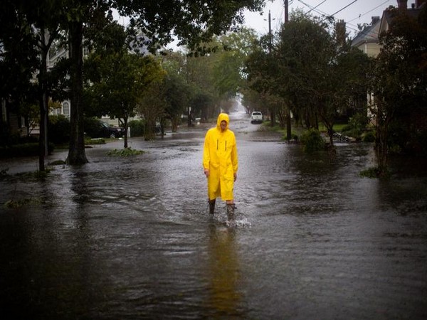 A man walks through flooded streets during the passing of Hurricane Florence in the town of New Bern