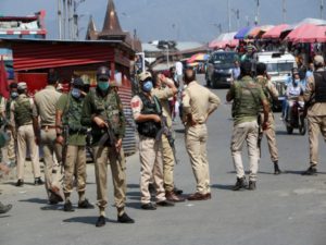 Police personnel stand guard at Lal Chowk after militants lobbed a grenade