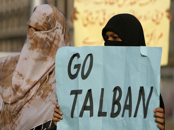 Women activists hold anti-Taliban banners while holding a demonstration in Lahore