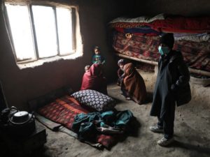 Internally displaced Afghan family sit at their shelter on the outskirts of Kabul