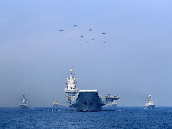 Warships and fighter jets of Chinese People's Liberation Army (PLA) Navy take part in a military display in the South China Sea