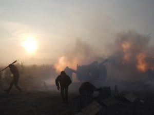 Ukrainian servicemen fire an artillery weapon near Novoluhanske in Donetsk region