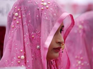 Brides  take part in a mass marriage ceremony in which, according to its organisers