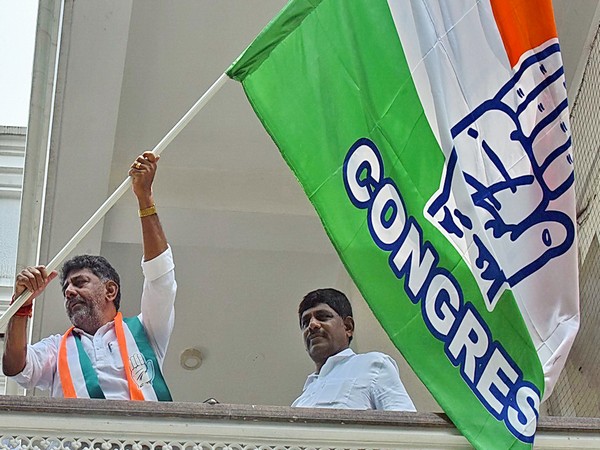 DK Shivakumar and party leader DK Suresh wave the party flag