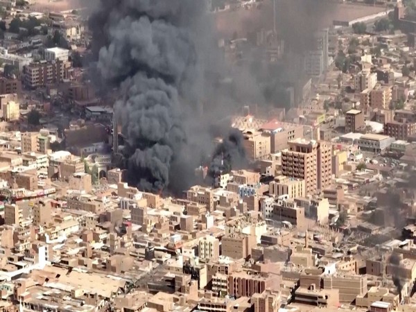 An aerial view of the black smoke and flames at a market in Omdurman