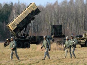 U.S soldiers walk next to  a Patriot missile defence battery during join exercises at the military grouds in Sochaczew