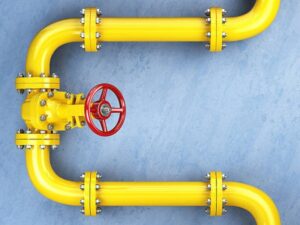 Yellow gas pipeline valve on a blue wall. Space for text. 3d illustration